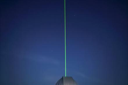 A light beam produced by the new lidar emerges from the dome at the Subauroral Geophysical Observatory at Gakona. Photo by Mike Roddewig