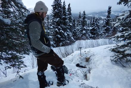 UAF graduate student Cole Richards installs a high-sampling seismic sensor in February 2019. It is one 400 placed along the Parks Highway following the 2018 magnitude 7.1 Anchorage earthquake. Graduate student Bella Seppi would later use the sensor data in her aircraft research. Photo by Carl Tape