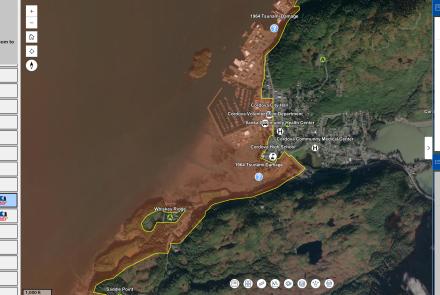 Screenshot of the Alaska Earthquake Center’s interactive tsunami hazard map centered on Cordova, Alaska. A satellite image shows the community, harbor and surrounding forested terrain, with a yellow boundary tracing the tsunami hazard area along the shoreline. 