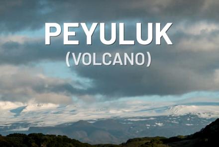 Landscape photo of a large volcano with the words "PEYULUK (VOLCANO)" superimposed on the image