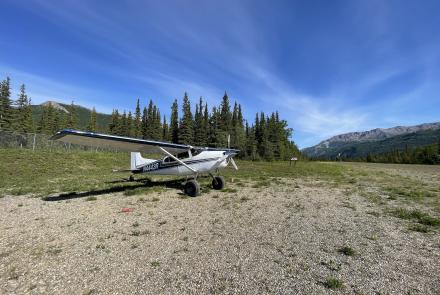 Small airplane on gravel runway