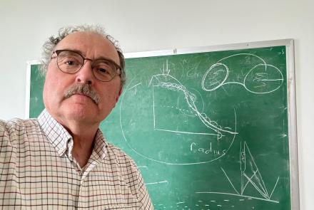 Person in front of a chalk board