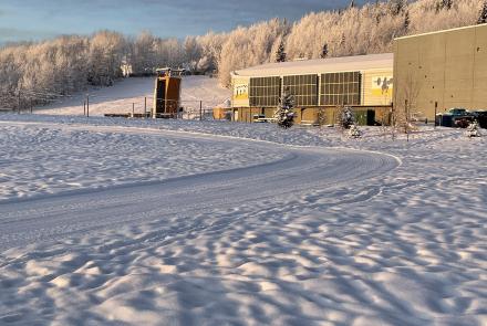 December sunshine lights a freshly groomed cross-country ski trail and the Student Recreation Center at the University of Alaska Fairbanks. Photo by Ned Rozell.