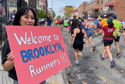 A woman welcomes runners to Brooklyn during the New York City Marathon on Nov. 6, 2022. Photo by Ned Rozell.