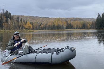 Biologist Erik Schoen gathers a water sample from a slough of the Chena River about 45 miles east of Fairbanks in September 2025. His team members will check the sample for possible DNA evidence of northern pike in the water. Photo by Ned Rozell.