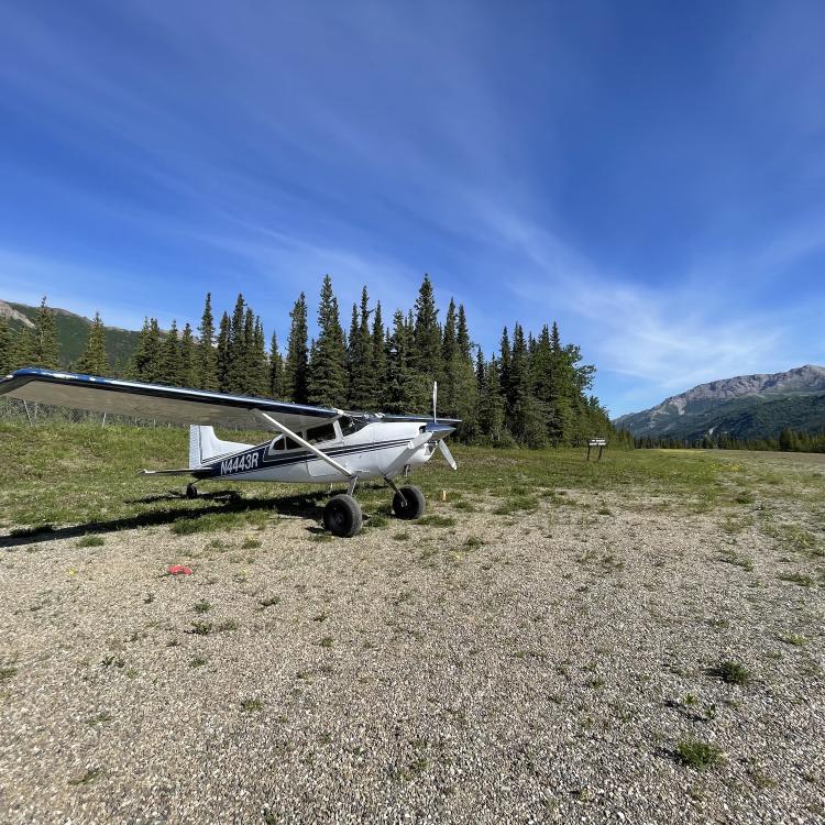 Small airplane on gravel runway