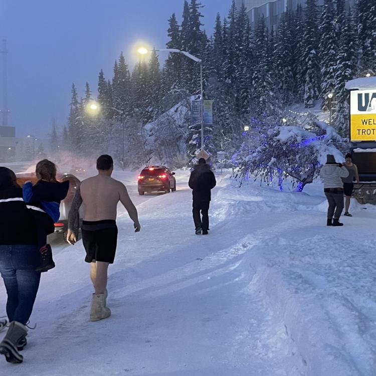 Fairbanks residents engage in a favorite cold-weather activity of taking photographs of themselves in front of the University of Alaska Fairbanks time-and-temperature sign on the morning of Jan. 27, 2024. Photo by Ned Rozell.