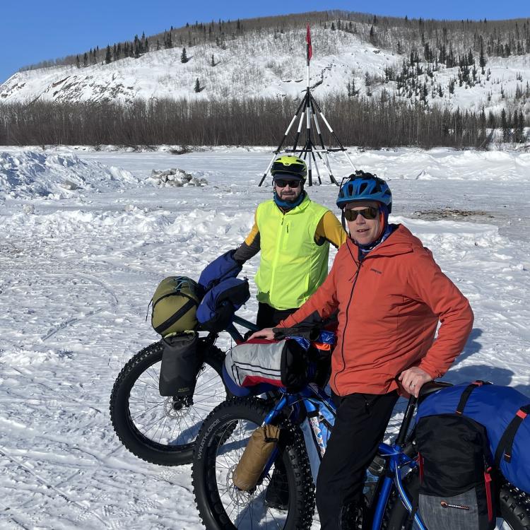 Forest Wagner, left, and Ned Rozell pause in front of the tripod on the ice of the Tanana River at the town of Nenana. When river ice breaks up, whoever guesses the exact time the tripod falls and pulls a cable will be the winner of the Nenana Ice Classic. Photo by Ned Rozell.