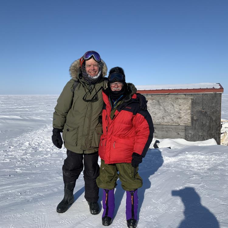 George Divoky and his friend Matt Thomas pose in front of Divoky’s cabin on Cooper Island after repairing polar-bear damage in April, 2022. Photo by Craig George.
